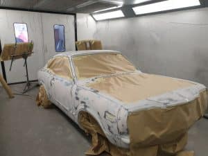 process of Mazda RX3 repainting in yellow