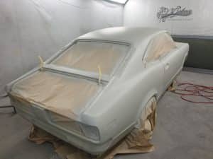 process of repainting an yellow Mazda RX3