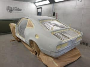 process of repainting yellow Mazda RX3