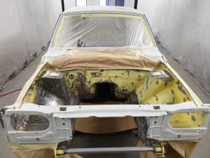 process of repainting an Mazda RX3 in yellow